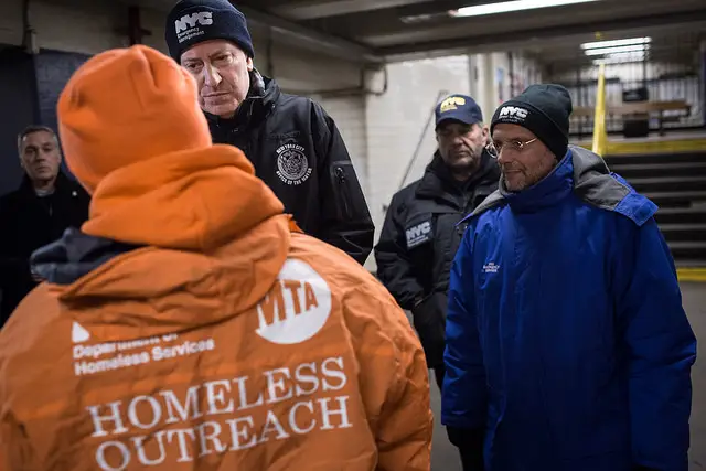 Mayor de Blasio, center, and homelessness and welfare Commissioner Steven Banks, right